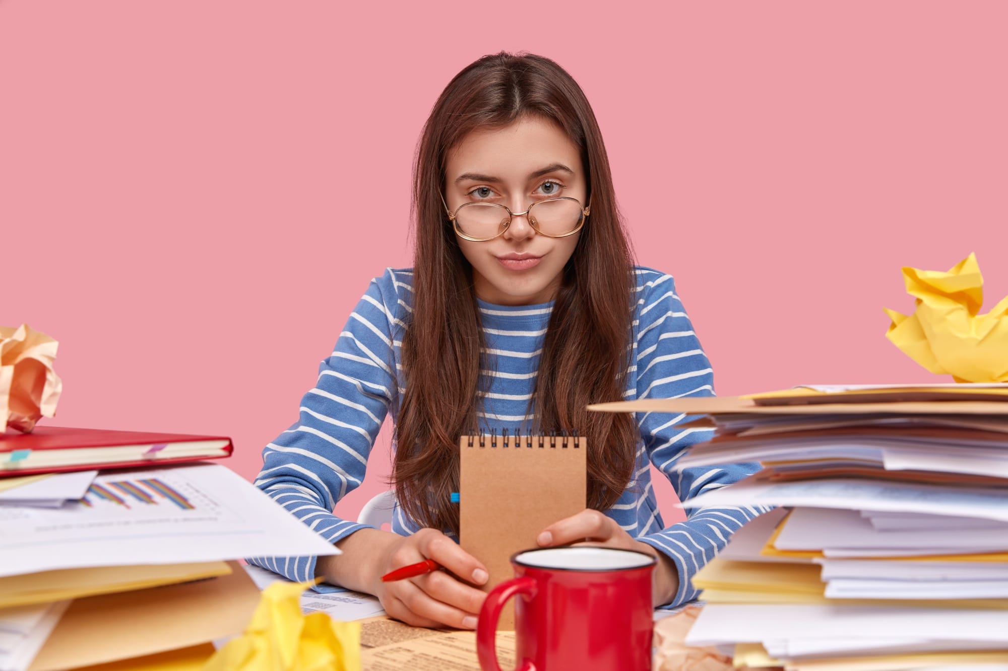 Female Student Overwhelmed With Books and Studies During Exams